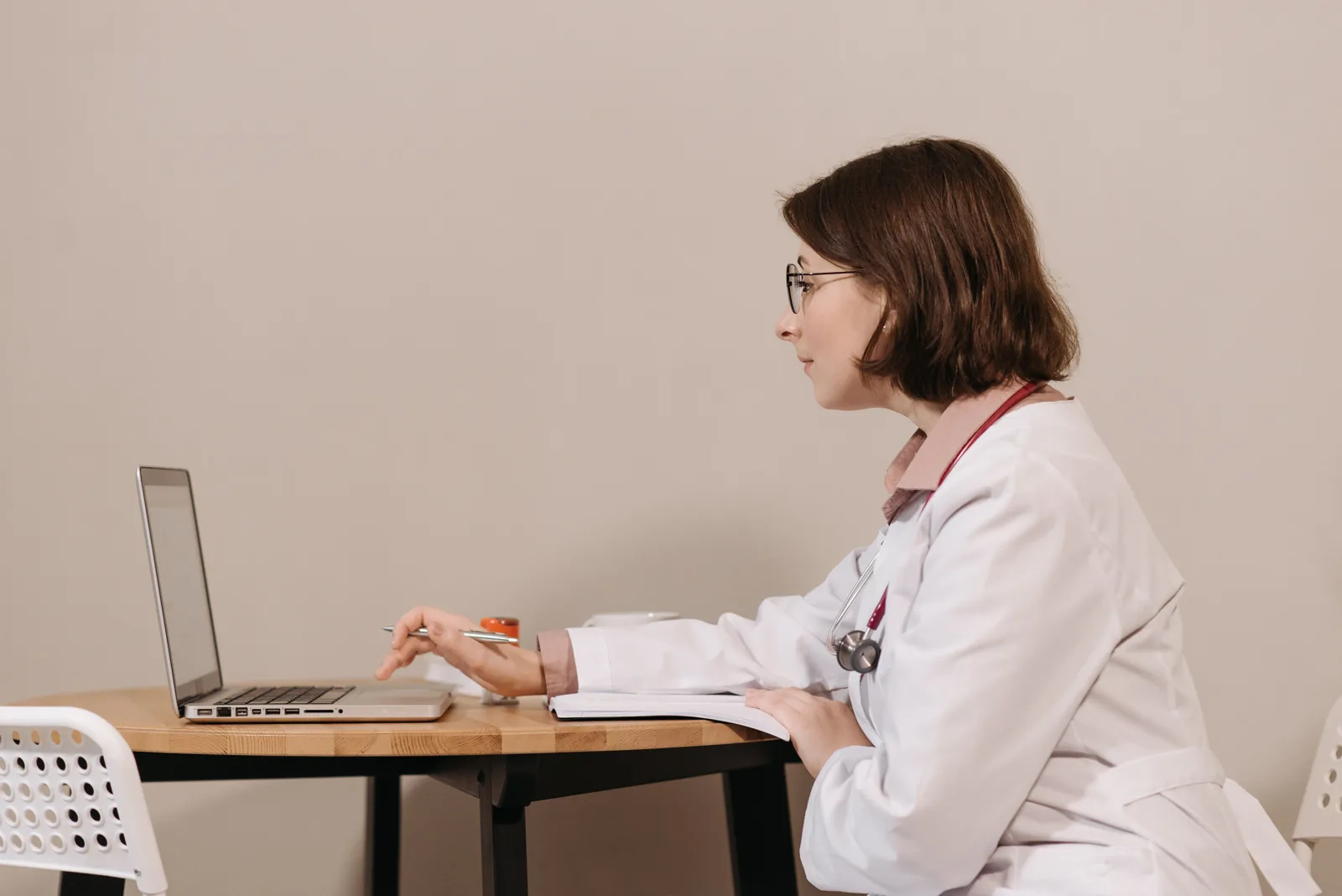 Physician reviewing information on a laptop