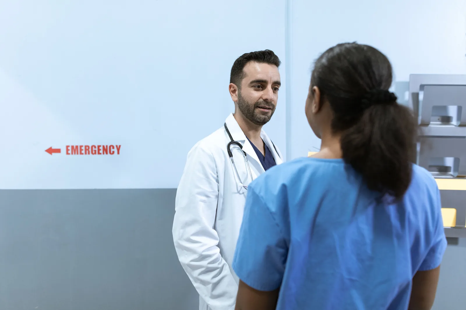 Doctor and nurse discussing work in a hospital setting